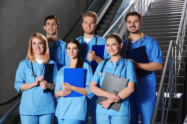 Tıp öğrencileri üniversite salonunda gülümseyen genç