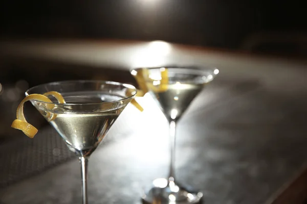 Glasses of lemon drop martini cocktail in bar, closeup. Space for text
