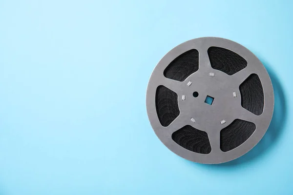 Movie reel on color background, top view with space for text. Cinema production