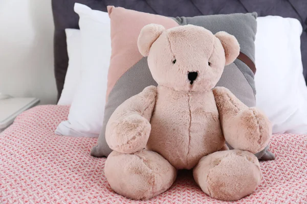 Cute Teddy Bear Sitting Bed Indoors — Stock Photo, Image