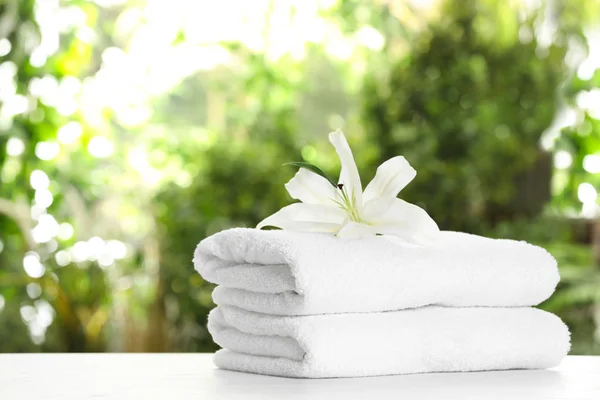 Stack Clean Soft Towels Flower Table Blurred Background Space Text — Stock Photo, Image