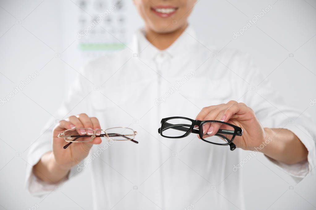 Female ophthalmologist with eyeglasses in clinic, closeup