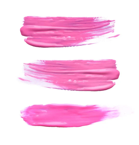 设置与抽象笔触的粉红色油漆在白色背景 顶部视图 — 图库照片