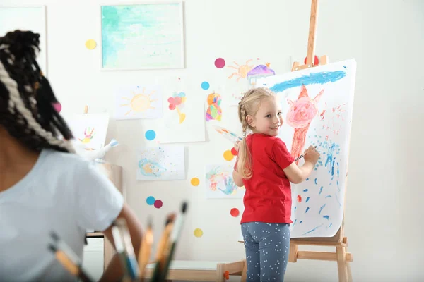 Cute Little Child Painting Easel Lesson Indoors — Stock Photo, Image