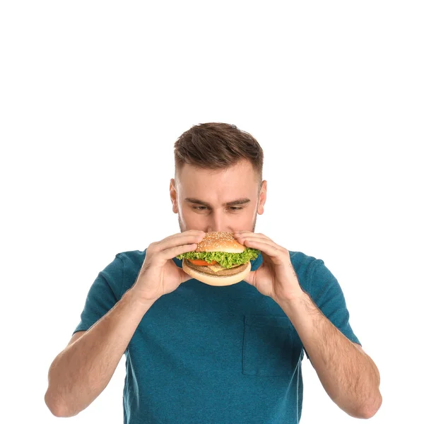 Jonge Man Eten Smakelijke Hamburger Witte Achtergrond — Stockfoto