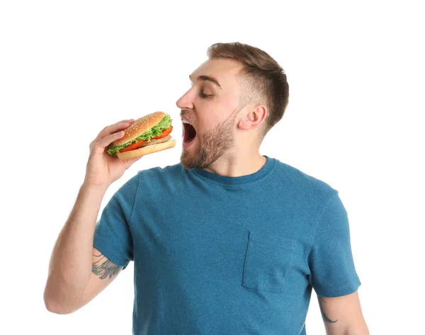 Joven Comiendo Sabrosa Hamburguesa Sobre Fondo Blanco —  Fotos de Stock