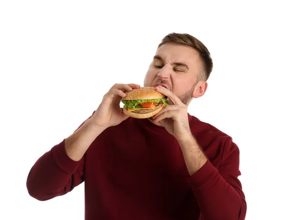 Mladý Muž Jíst Chutné Burger Bílém Pozadí — Stock fotografie