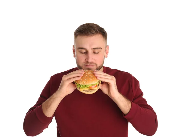 Jovem Comendo Hambúrguer Saboroso Fundo Branco — Fotografia de Stock