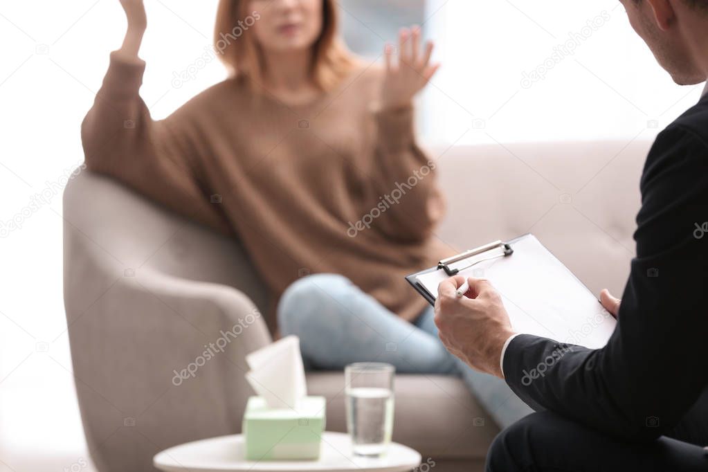 Psychotherapist working with woman in office, closeup