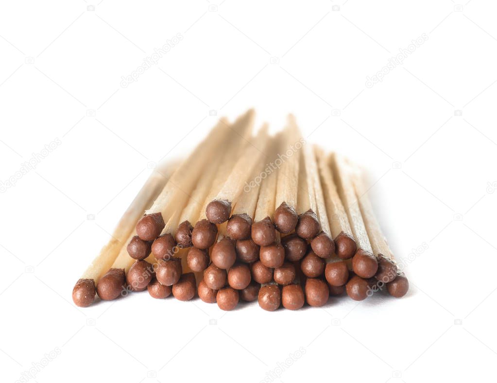 Pile of wooden matches on white background