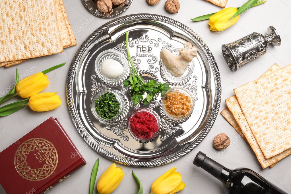 Flat lay composition with symbolic Passover (Pesach) items on color background