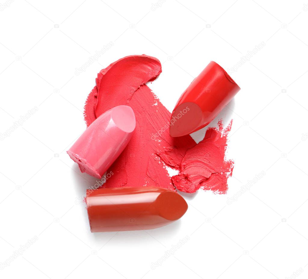 Stroke and lipsticks on white background, top view
