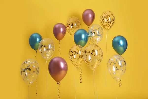 Balões Brilhantes Com Fitas Sobre Fundo Cor — Fotografia de Stock