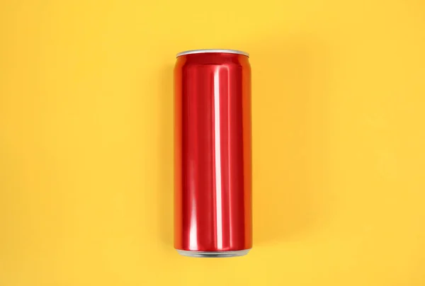 Blank metal red can on color background, top view. Mock up for design