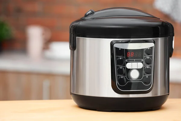 Modern electric multi cooker on table in kitchen. Space for text — Stock Photo, Image