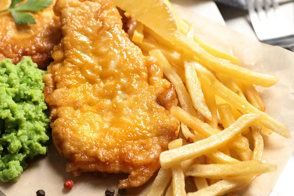 British traditional fish and potato chips on table, closeup