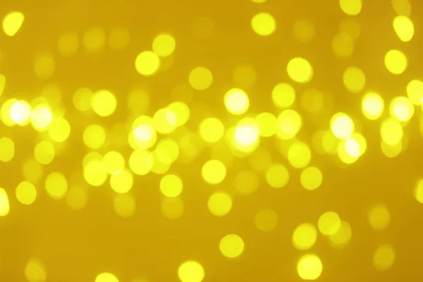 Vista borrosa de luces doradas brillantes. Efecto Bokeh — Foto de Stock