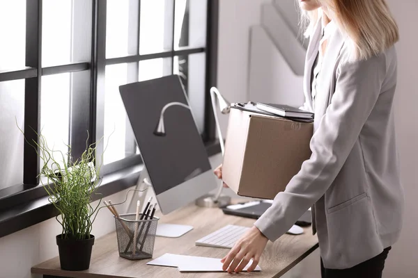 Jeune femme tenant boîte de déménagement avec des choses de bureau à l'intérieur, gros plan — Photo