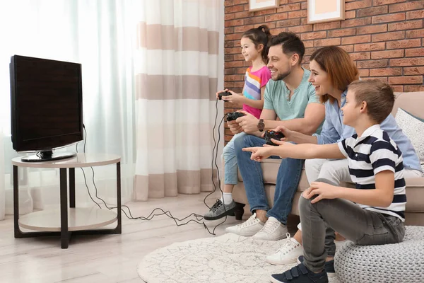 Glückliche Familie spielt Videospiele im Wohnzimmer — Stockfoto