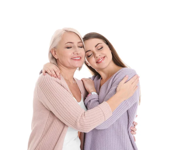 Portrait of young woman with her mature mother on white background — Stock Photo, Image