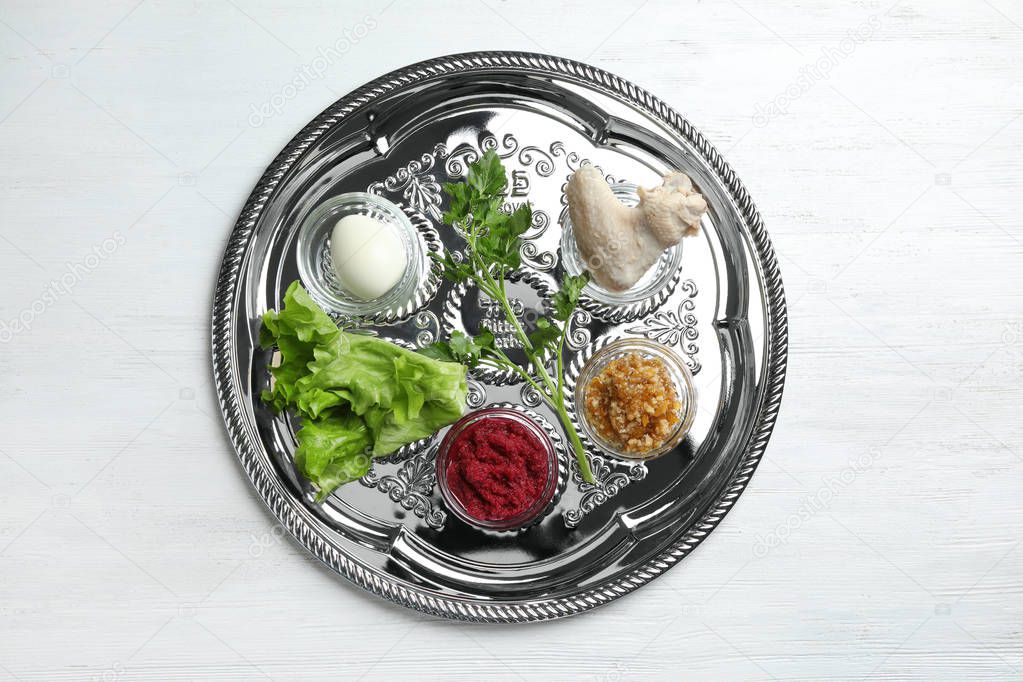Traditional silver plate with symbolic meal for Passover (Pesach) Seder on wooden background, top view