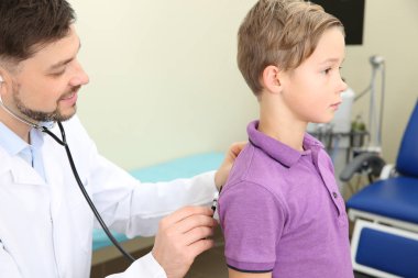 Erkek doktor hastanede stetoskop ile küçük çocuk incelenmesi