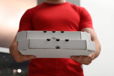 Kurye ile pizza kutuları arka plan bulanık, closeup üzerinde