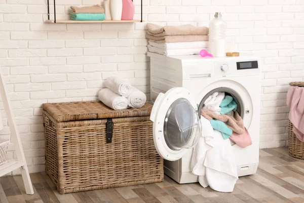 Интерьер ванной комнаты с грязными полотенцами в стиральной машине — стоковое фото