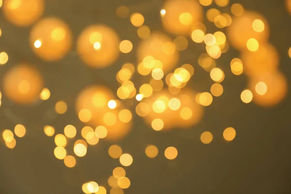 Blurred view of gold lights on dark background. Bokeh effect — Stock Photo, Image