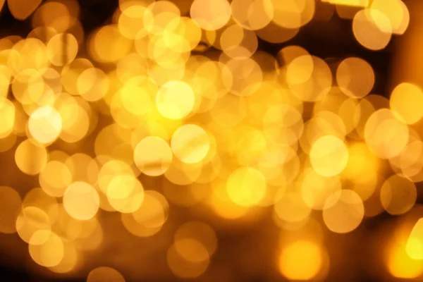 Gouden glitter met bokeh effect op donkere achtergrond — Stockfoto