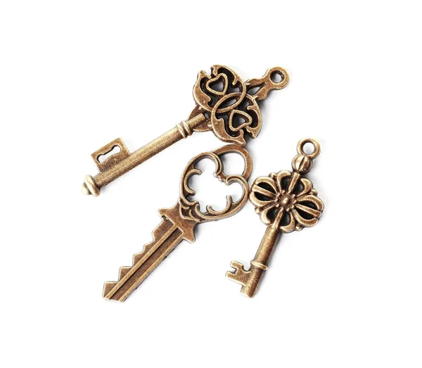 Bronze vintage ornate keys on white background, top view — Stock Photo, Image