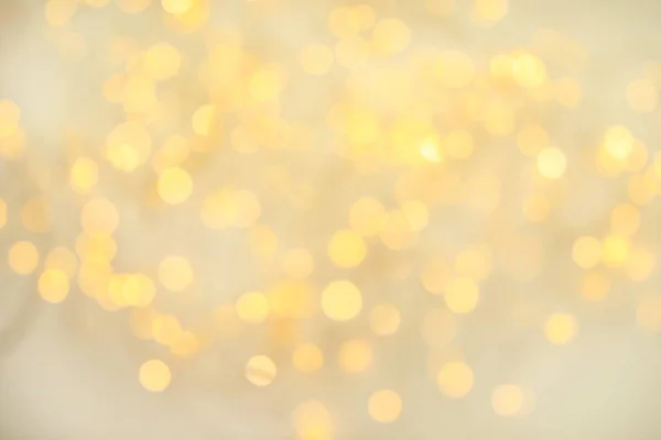 Guld glitter med bokeh effekt på ljus bakgrund — Stockfoto