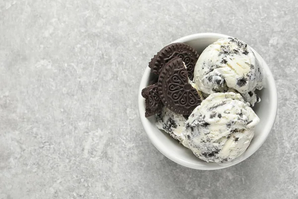 Bowl of chocolate cookies ice cream on grey background, top view with space for text — Stock Photo, Image