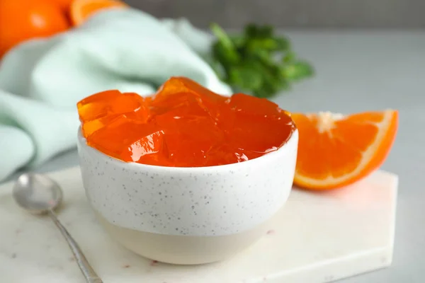 Composition with orange jelly in bowl on table — Stock Photo, Image