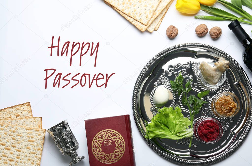 Flat lay composition of symbolic Pesach items on white background. Happy Passover