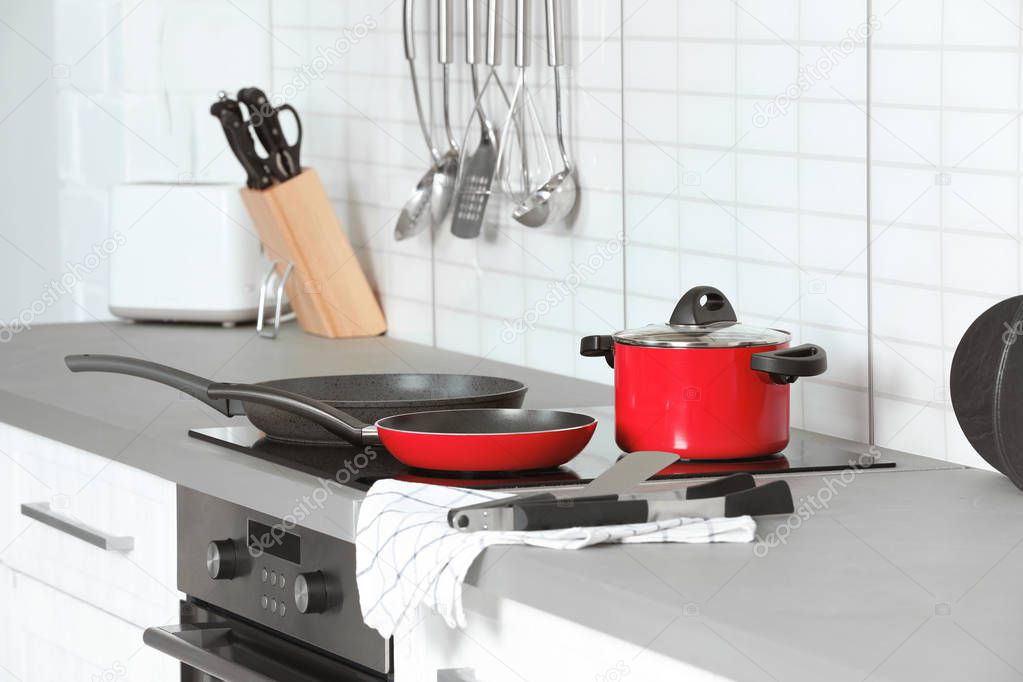 Different clean cookware and utensils in kitchen