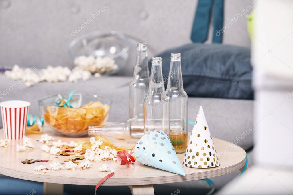 Wooden table with mess after party indoors
