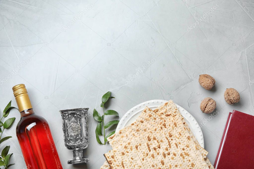 Flat lay composition with symbolic Passover (Pesach) items on light background, space for text