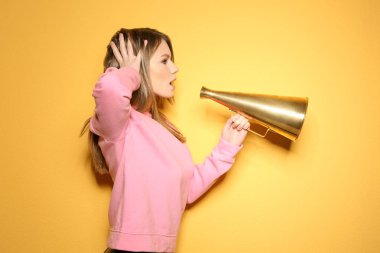 Young woman with megaphone on color background clipart