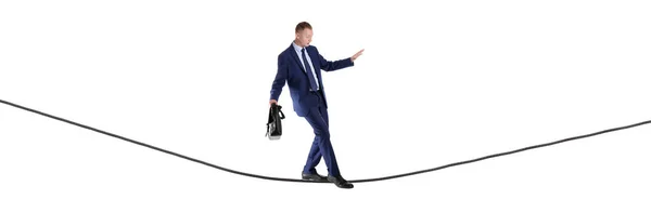 Businessman with briefcase balancing on rope against white background — Stock Photo, Image