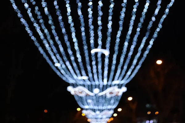 Beautiful bright Christmas decor outdoors, low angle view. Bokeh effect — Stock Photo, Image