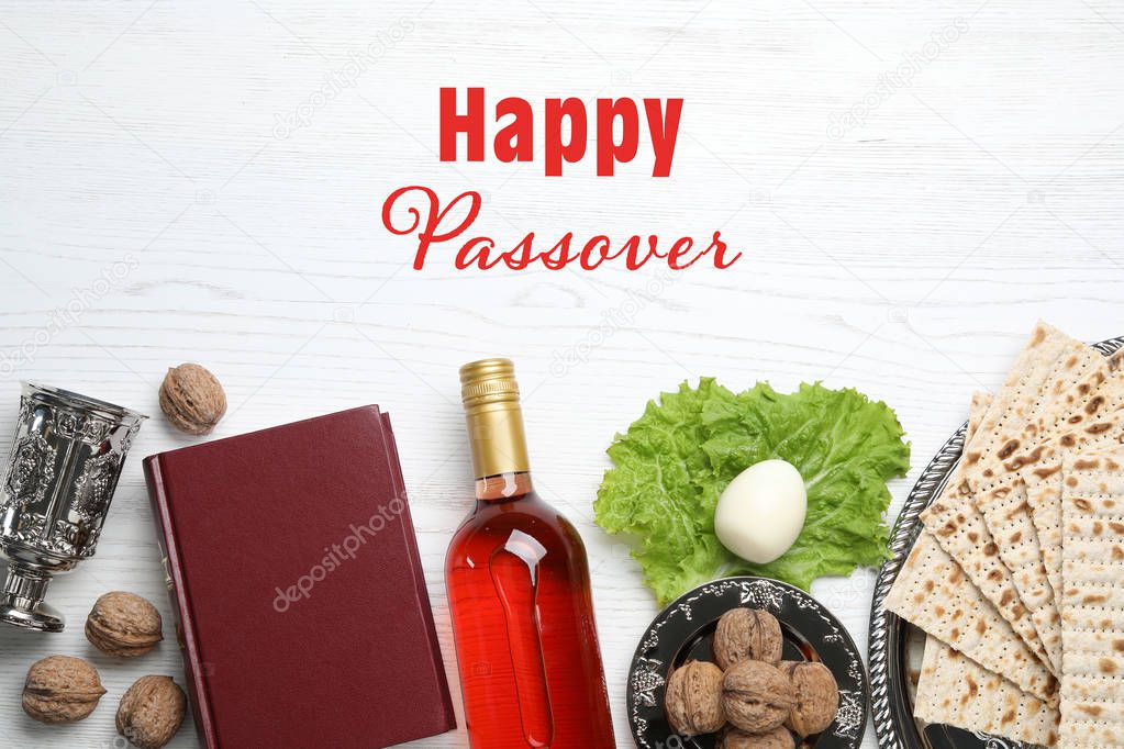 Flat lay composition of symbolic Pesach items on wooden background. Happy Passover