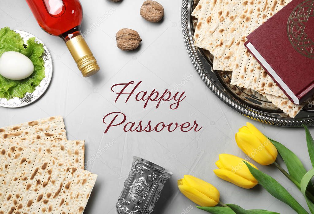 Flat lay composition of symbolic Pesach items on light background. Happy Passover