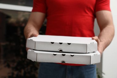 Kurye ile pizza kutuları arka plan bulanık, closeup üzerinde
