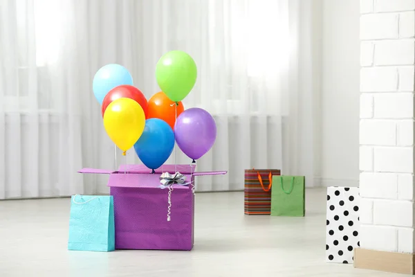 Presentask med ljusa air ballonger på golv inomhus. Utrymme för text — Stockfoto