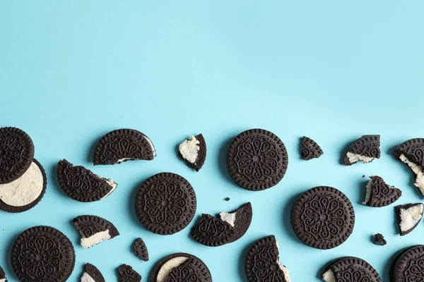 Biscoitos de chocolate saborosos com creme sobre fundo de cor, flat lay. Espaço para texto — Fotografia de Stock