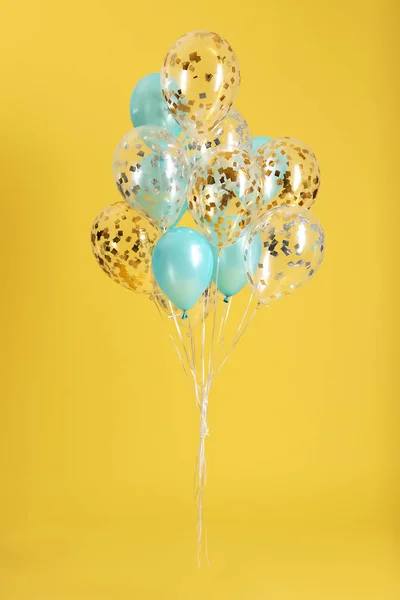 Bunch of bright balloons on color background — Stock Photo, Image