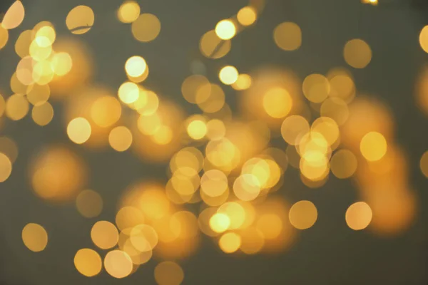 Blurred view of gold lights on dark background. Bokeh effect — Stock Photo, Image