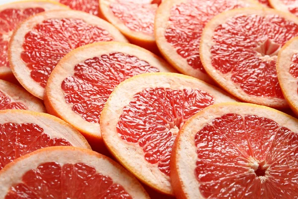 Viele aufgeschnittene frische reife Grapefruits als Hintergrund, Nahaufnahme — Stockfoto