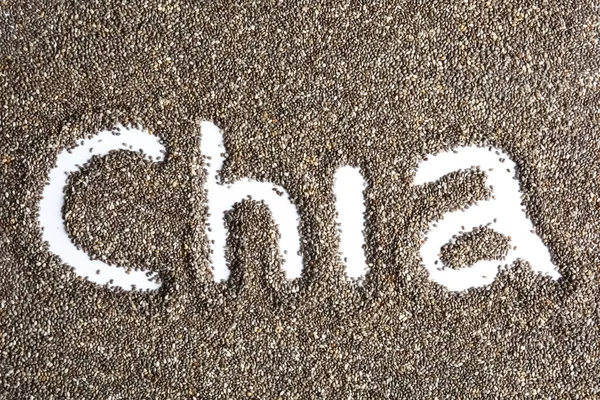 Parola CHIA scritta in semi su sfondo bianco, vista dall'alto — Foto Stock